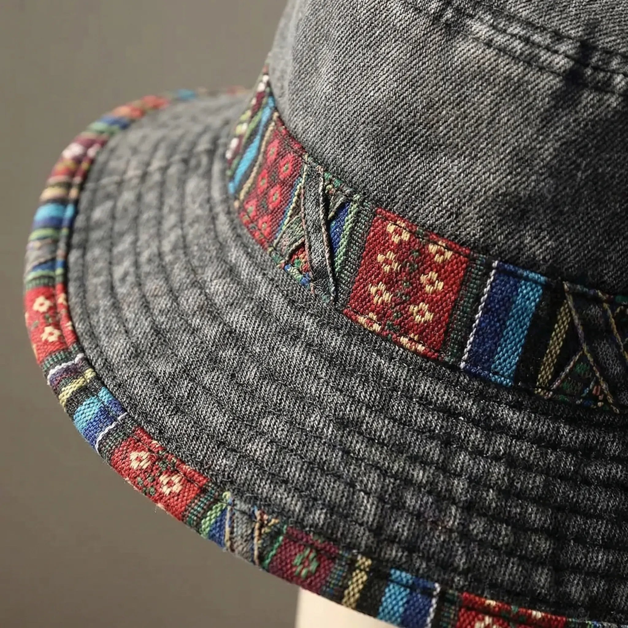 Wide-brim bucket hat with boho woven trim and adjustable chin cord