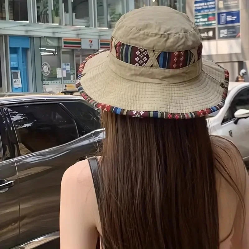 Wide-brim bucket hat with boho woven trim and adjustable chin cord