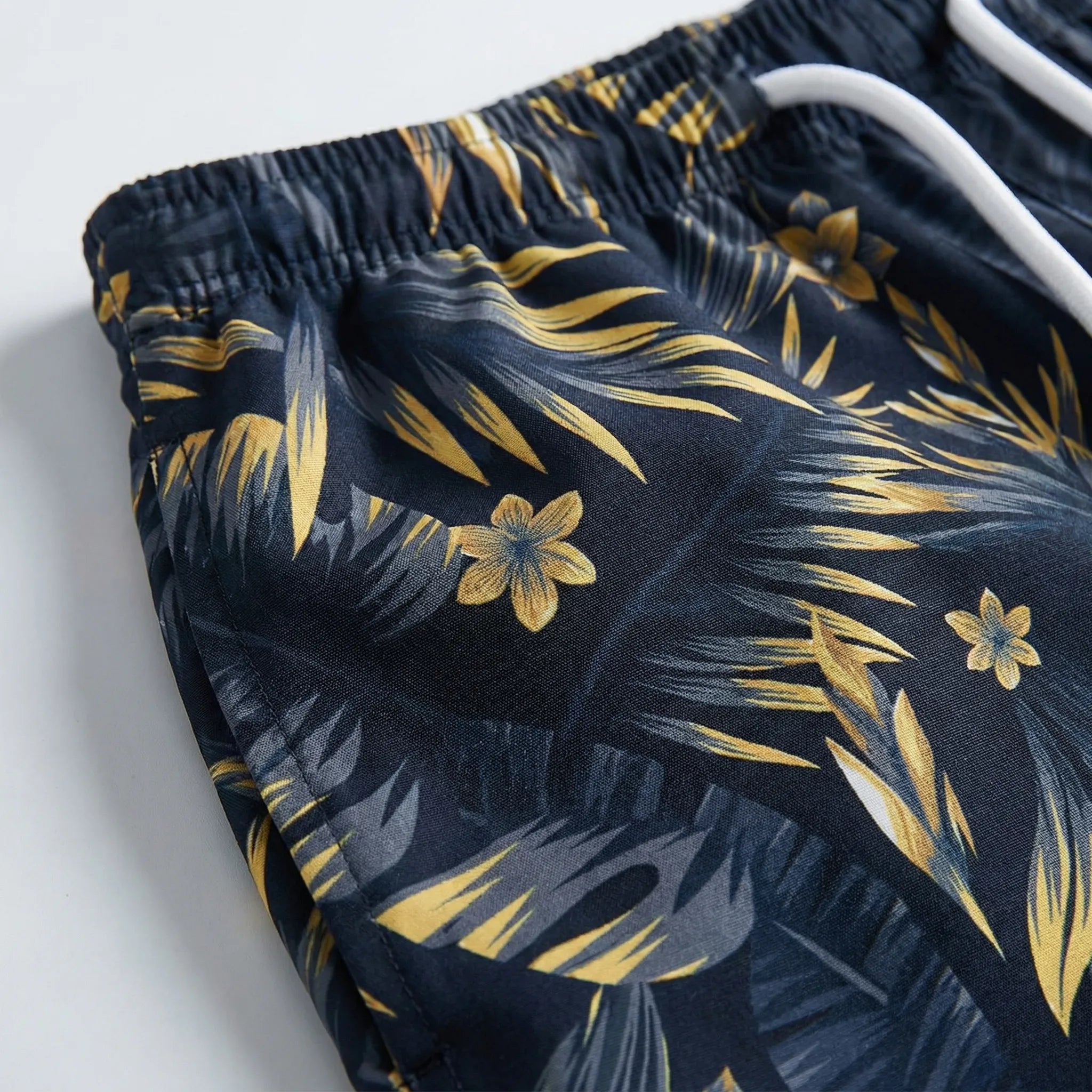 Men's relaxed fit swim shorts with quick-dry tropical leaf print